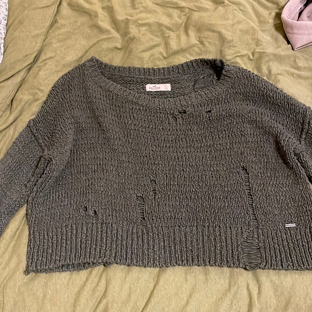 Small Hollister Olive green sweater with fashion rips.